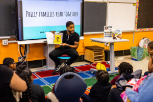 An author reads his book to a group of children and their grandparent caregivers at a Philly Families Read Together workshop.