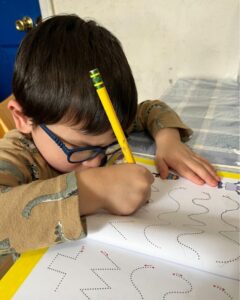 A grandchild in the Philly Families Read Together program practices line formation.