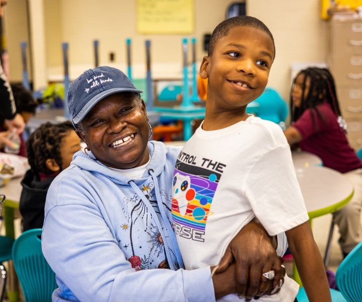 At a Philly Families Read Together event, a grandmother embraces her grandchild.