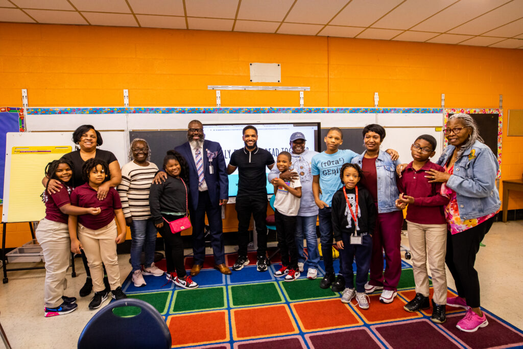 At a Philly Families Read Together event, grandfamilies pose with the guest speaking author.