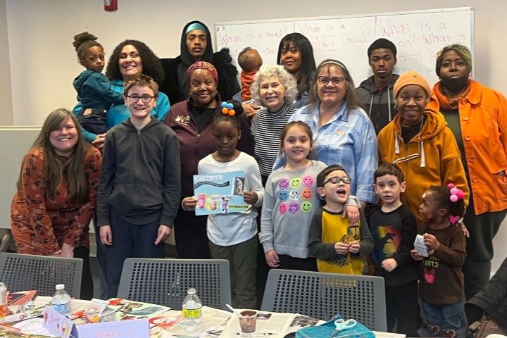 At a GrandFamily Resource Center event, a group of grandparents and grandchildren pose together.